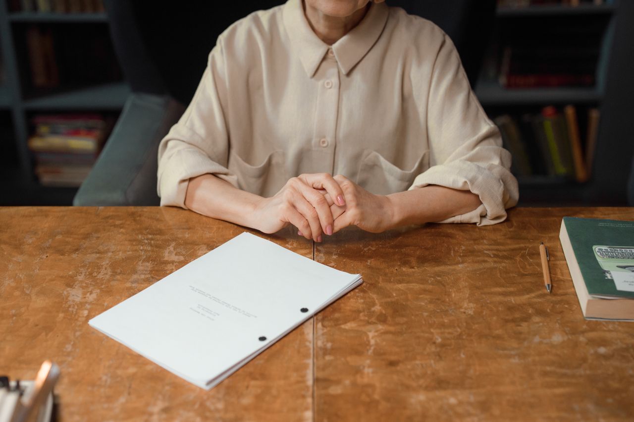 Woman sitting at desk reviewing screenplay